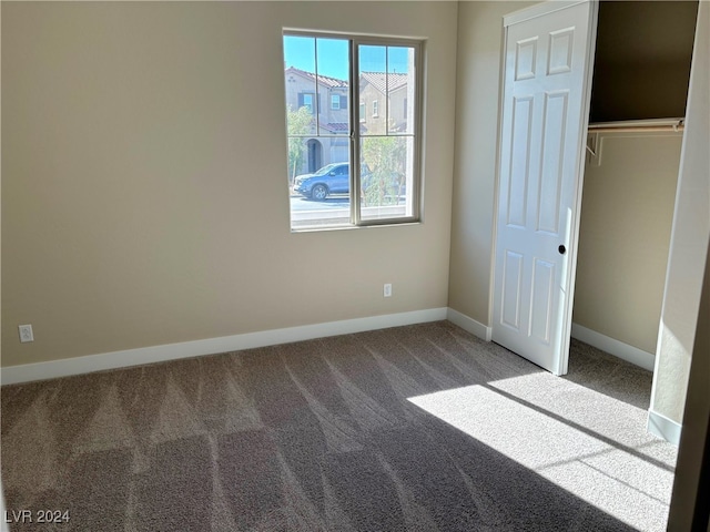 unfurnished bedroom featuring carpet floors and a closet