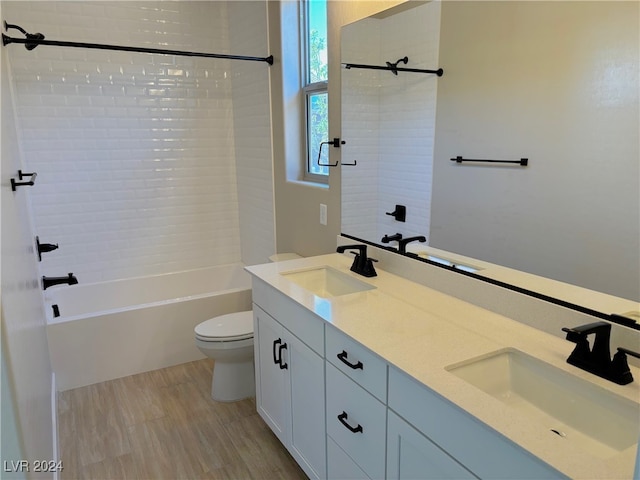 full bathroom featuring vanity, toilet, and tiled shower / bath