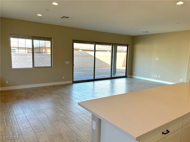 unfurnished room featuring light hardwood / wood-style floors and a healthy amount of sunlight