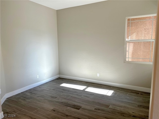 empty room with dark hardwood / wood-style floors