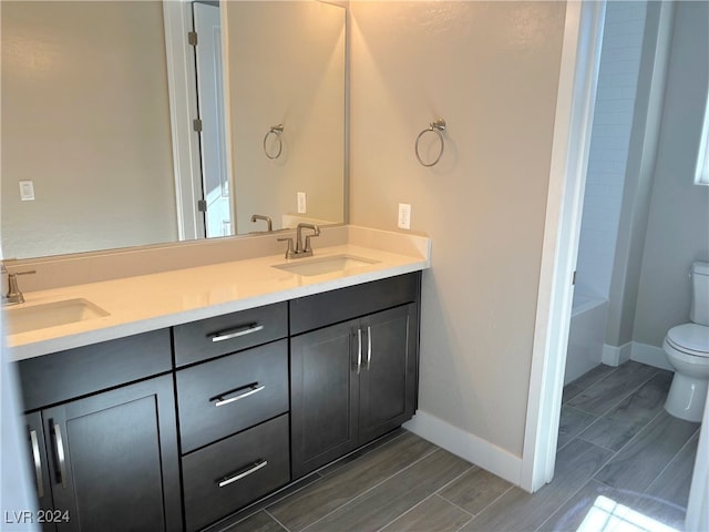 bathroom featuring hardwood / wood-style floors, vanity, and toilet