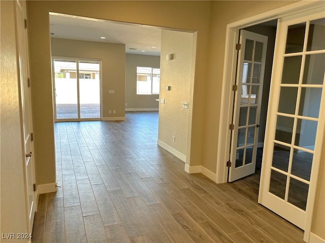 interior space with wood-type flooring and french doors