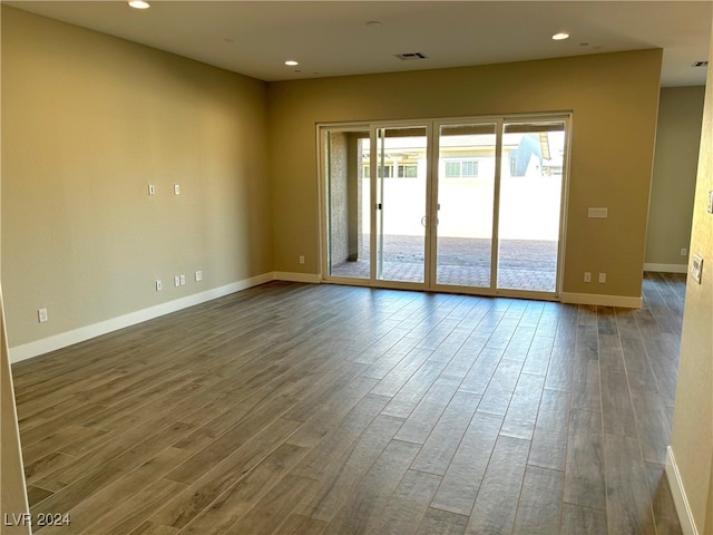 unfurnished room featuring hardwood / wood-style flooring