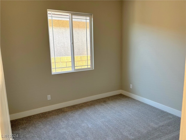 carpeted spare room featuring a healthy amount of sunlight