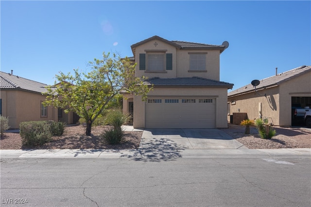 front of property featuring a garage and central AC