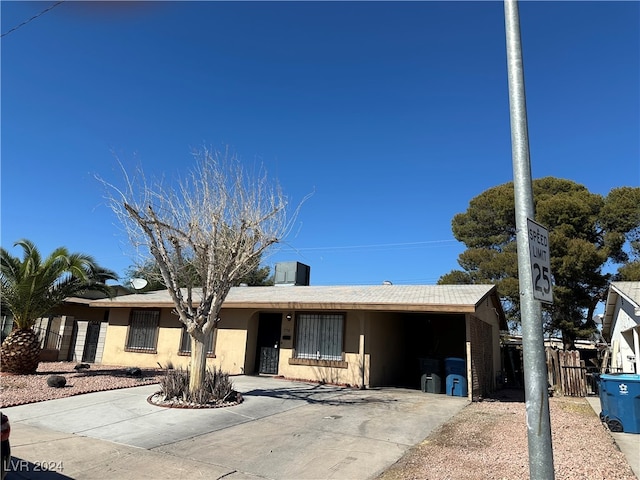 single story home with a carport