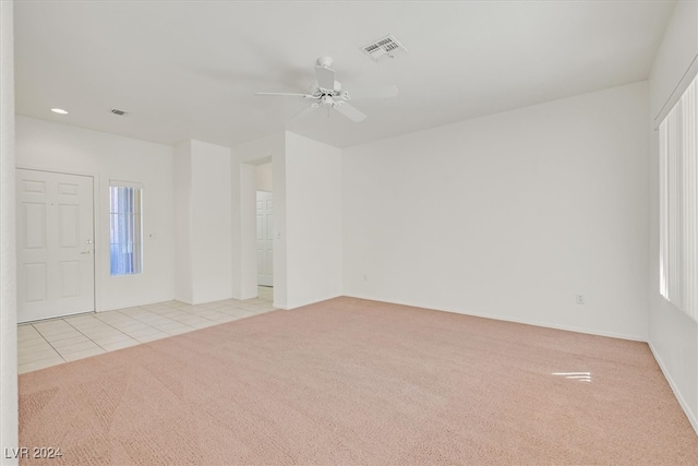 interior space with ceiling fan and light carpet