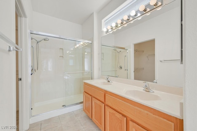 bathroom with tile patterned floors, an enclosed shower, and vanity