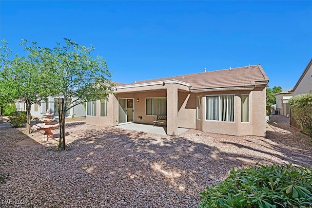 rear view of property featuring a patio area