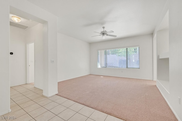 empty room with ceiling fan and light colored carpet