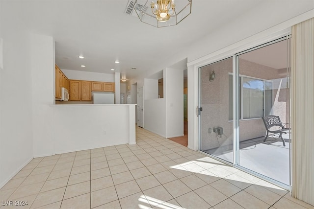 interior space featuring a notable chandelier and light tile patterned flooring