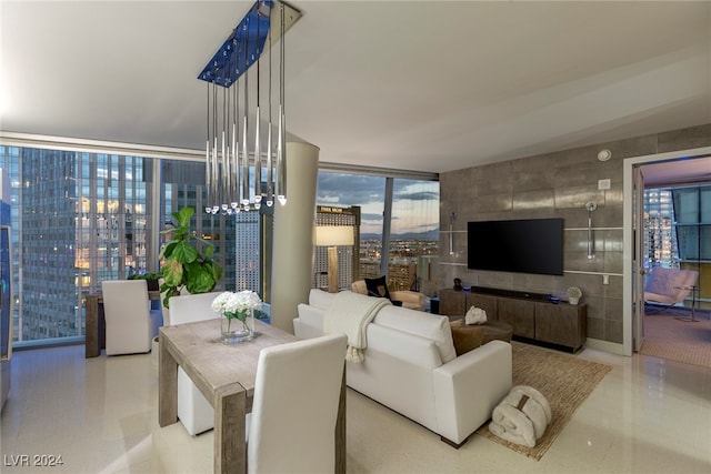 living room featuring an inviting chandelier and floor to ceiling windows