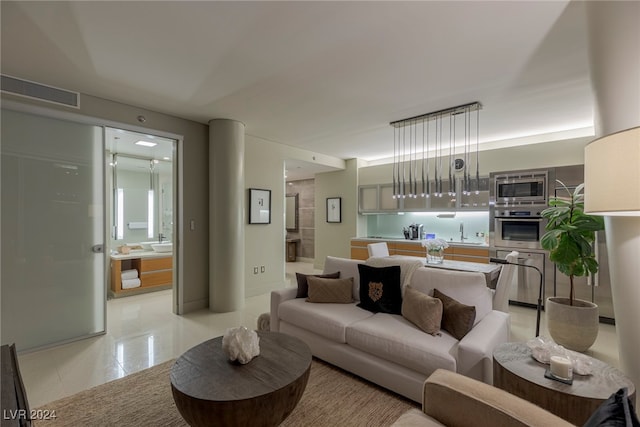 living room with light tile patterned flooring and sink