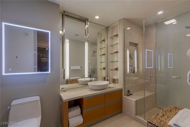 bathroom with tile patterned flooring, vanity, toilet, and an enclosed shower