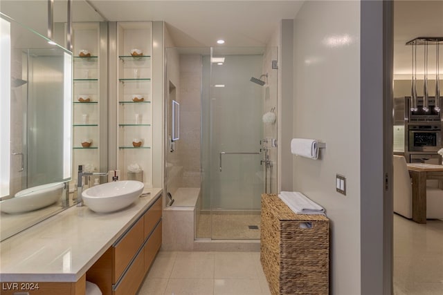 bathroom featuring tile patterned flooring, vanity, and an enclosed shower