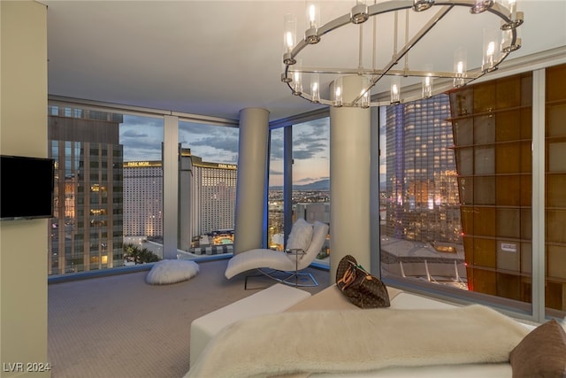 bedroom featuring carpet, floor to ceiling windows, and a chandelier