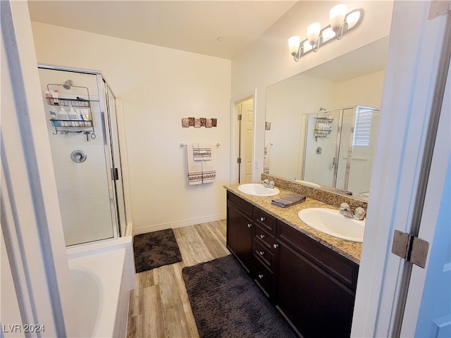 bathroom with vanity, shower with separate bathtub, and hardwood / wood-style floors