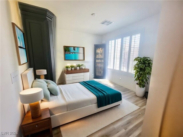 bedroom with light hardwood / wood-style flooring