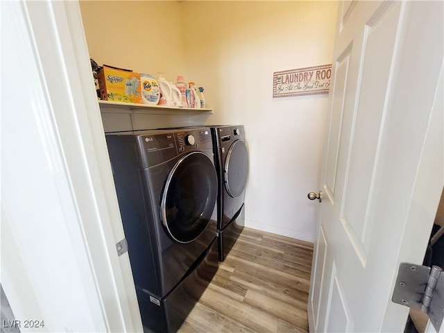 laundry area featuring light wood-type flooring and washing machine and clothes dryer