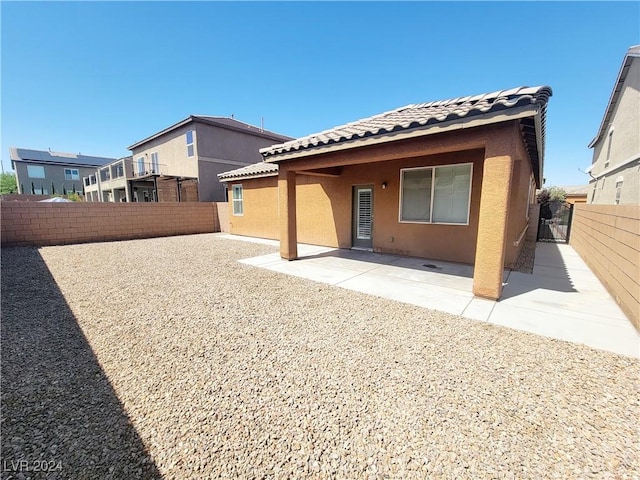 1152 Bear Head St, Henderson, NV 89011 - back of house with stucco siding, a tiled roof, a patio, and a fenced backyard