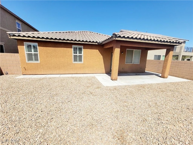 1152 Bear Head St, Henderson, NV 89011 - back of house with a tile roof, stucco siding, fence, and a patio area
