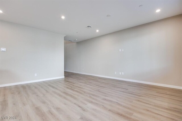spare room with baseboards, visible vents, recessed lighting, and light wood-type flooring