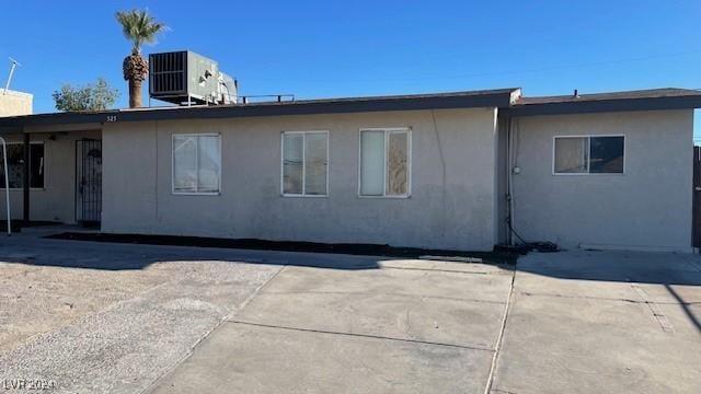 rear view of house featuring central AC unit and a patio area