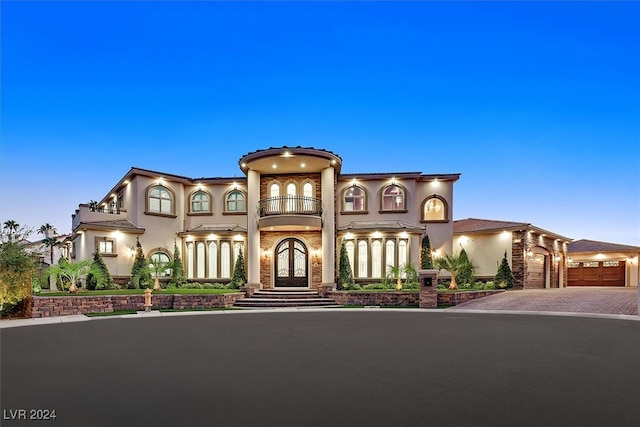 mediterranean / spanish-style house with a balcony and a garage