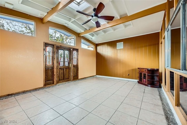 tiled entrance foyer featuring lofted ceiling with beams, ceiling fan, and wooden walls