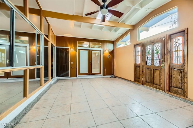 interior space with lofted ceiling with beams, a wealth of natural light, and ceiling fan