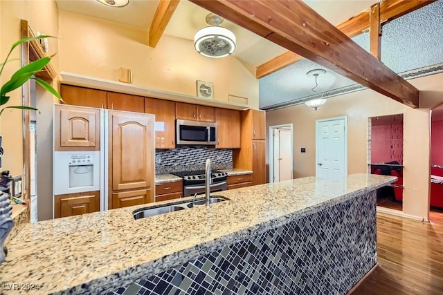 kitchen featuring tasteful backsplash, stainless steel appliances, beamed ceiling, hardwood / wood-style floors, and hanging light fixtures