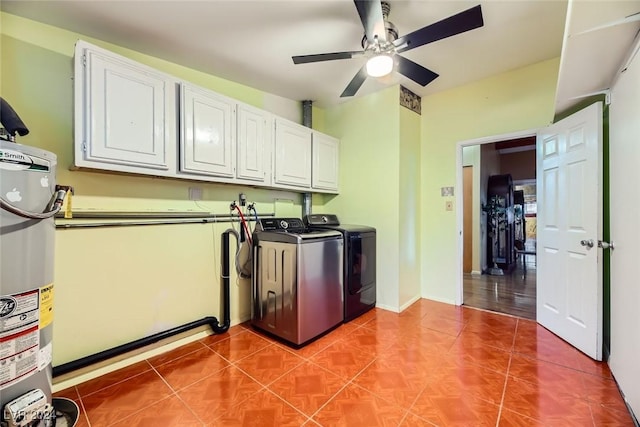 laundry area with ceiling fan, cabinets, washing machine and dryer, water heater, and tile patterned floors