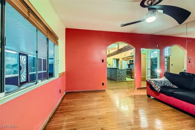 living room with light hardwood / wood-style flooring and ceiling fan