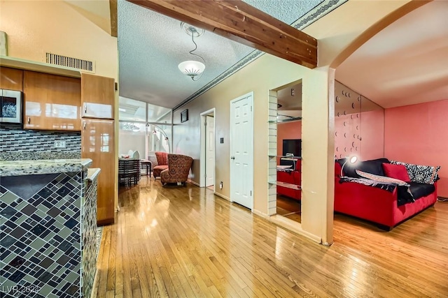 interior space featuring decorative backsplash and hardwood / wood-style flooring