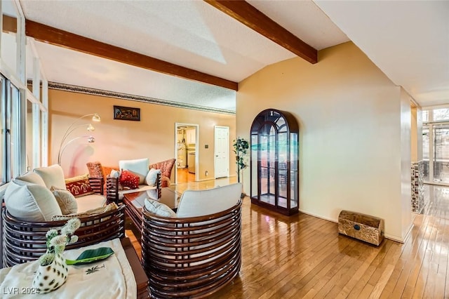 living room with vaulted ceiling with beams and wood-type flooring