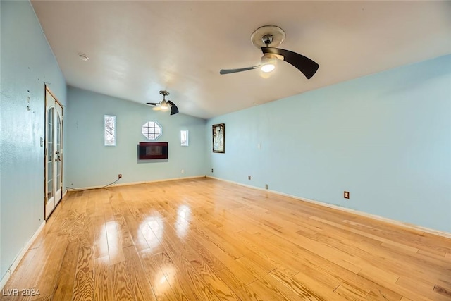 interior space with vaulted ceiling and light hardwood / wood-style flooring