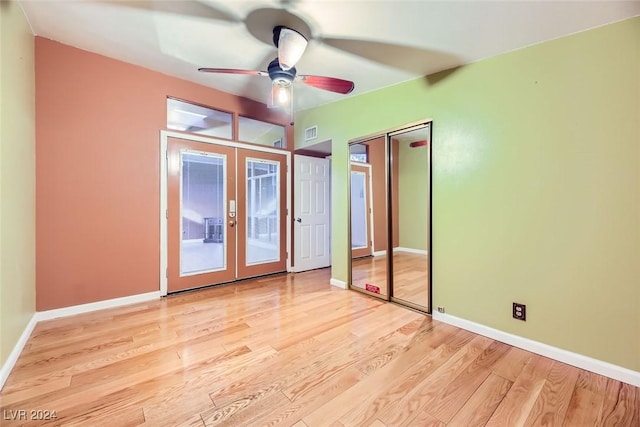 unfurnished bedroom with french doors, light hardwood / wood-style floors, and ceiling fan