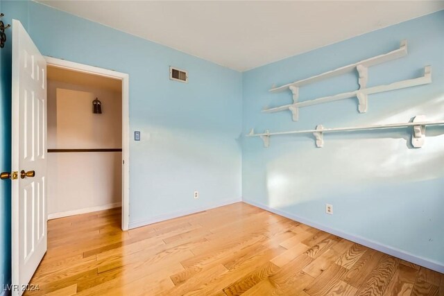 unfurnished room with light wood-type flooring