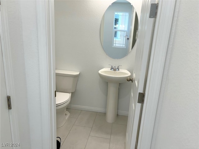 bathroom with tile patterned flooring and toilet