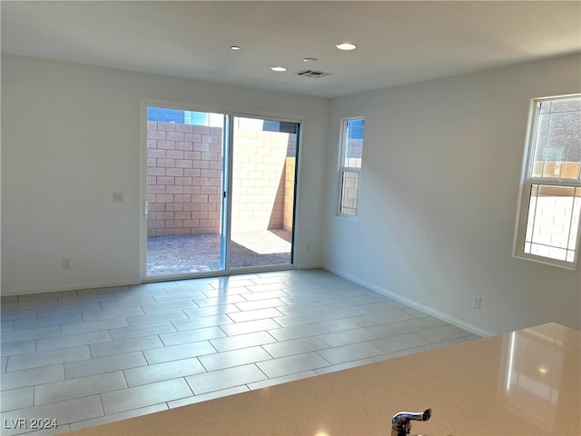 tiled empty room with plenty of natural light