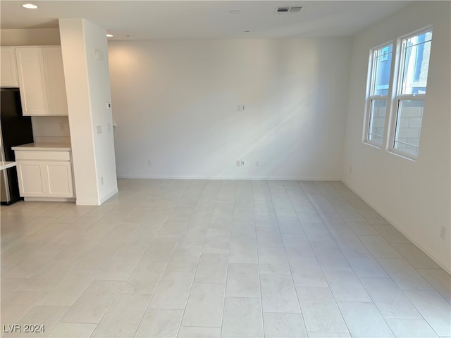 unfurnished living room featuring light tile patterned floors