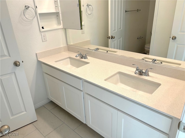 bathroom featuring tile patterned floors, vanity, and toilet