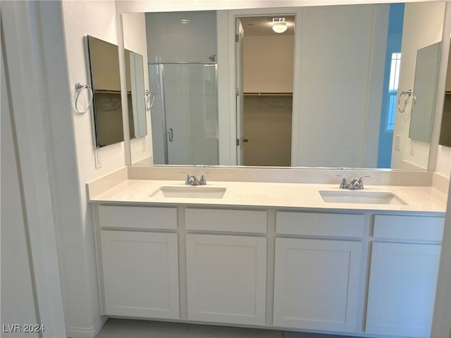 bathroom with vanity and a shower with shower door