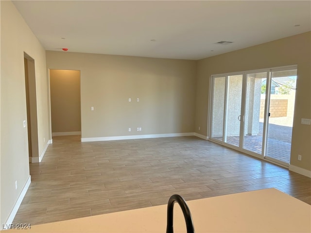 unfurnished room with light wood-type flooring