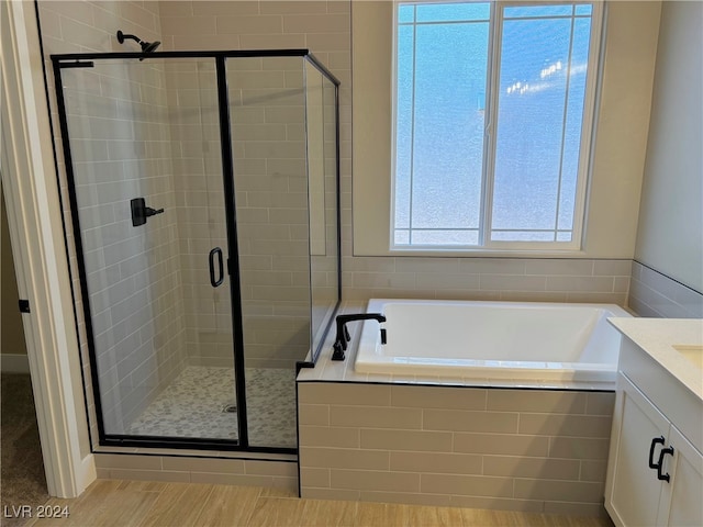 bathroom featuring vanity and plus walk in shower