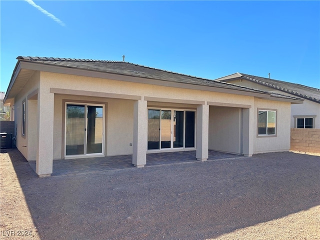 rear view of property featuring a patio area and central AC