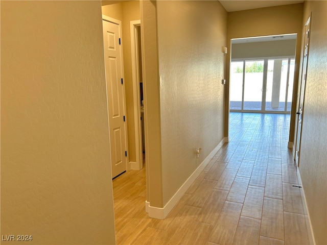 hallway with light hardwood / wood-style flooring