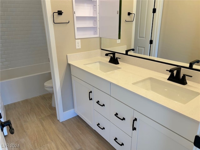 bathroom with hardwood / wood-style floors, vanity, and toilet