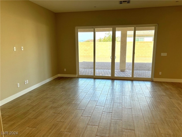 empty room with light hardwood / wood-style flooring