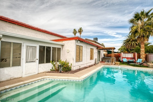 view of pool featuring a patio and central AC